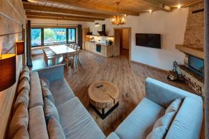 a living room with a couch and a table at Шале 5 Стефанія in Mykulychyn