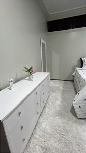 a bedroom with a white dresser and a bed at Família Macapá in Macapá