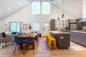 Una cocina y una sala de estar con mesa y sillas. en Hare & Hollow with Hot Tub & Fenced Yard, en Long Eddy