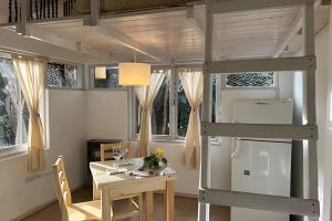 a room with a dining table and a loft bed at La Perla - Centro de El Bolsón. in El Bolsón
