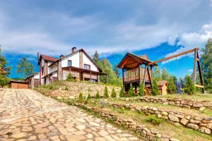 a house on top of a hill with a playground at Шале 5 Стефанія in Mykulychyn