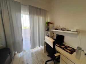 a room with a desk with a chair and a window at Apartment with garden views 525 in Punta Cana