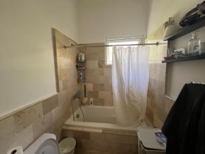a bathroom with a tub and a toilet and a sink at Apartment with garden views 525 in Punta Cana