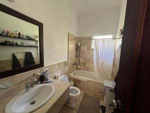a bathroom with a sink and a toilet and a tub at Apartment with garden views 525 in Punta Cana