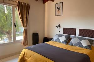a bedroom with a bed and a window at Copos de Nieve in El Bolsón