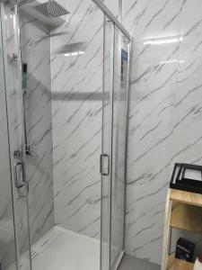 a shower with a glass door in a bathroom at Orion Casais in Casais