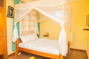 Postel nebo postele na pokoji v ubytování Bamboo Savanna Villas + 30 fotografií