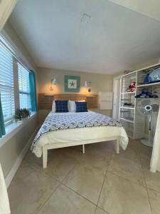 a bedroom with a large bed with blue pillows at Cozy Beach Rental 1B/1B in St Pete Beach