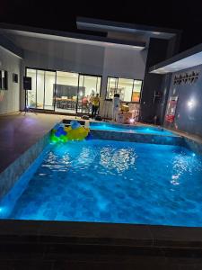 ein großer Pool mit blauen Lichtern in einem Gebäude in der Unterkunft Saltos Luxury - Quincho & Piscina in Salto del Guairá