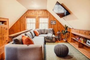 a living room with two couches in a attic at Breathtaking River Views The Hawks Nest Cabin in Glen Spey