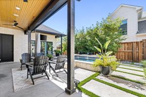a patio with chairs and a table and a pool at The Fairway on Maple in Frisco