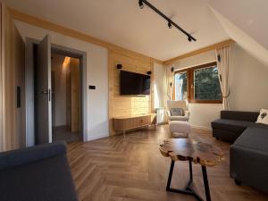 ein Wohnzimmer mit Sofa und Tisch in der Unterkunft Muran Apt in Zakopane