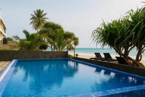 a swimming pool with a view of the beach at Beyond The Sea By Ceylonese in Ambalangoda