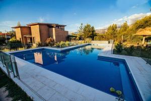 een zwembad in een tuin met een huis bij Soles de Belen in Carpintería