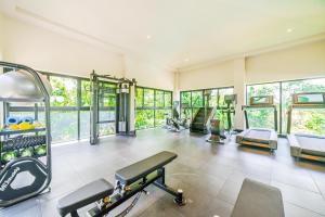 a gym with several treadmills and machines at Brisa del Valle at Naumi, Ocean Views & Beach Club in Coco +25 photos