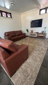 a living room with a couch and a flat screen tv at Família Macapá in Macapá +30 photos