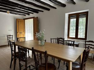 a dining room with a wooden table and chairs at Casa Fuente Rivera - Casa completa para grupos, hasta 14 personas in Moratalla