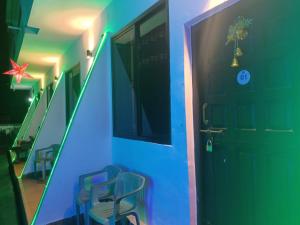 a hallway with blue and green lights next to a door at Carolina Deluxe GuestHouse Wi-Fi in Colva