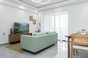 a living room with a couch and a table at Diamond Ivy Two Bedroom Apartment, Swimming pool, gym, workspace ,Wonderiss Homes Kileleshwa Living in Nairobi