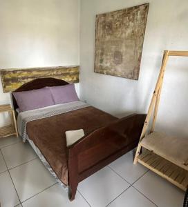 a bedroom with a bed and a painting on the wall at Pousada Costeira Barra do Sul in Balneario Barra do Sul