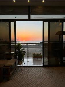 a room with a view of the ocean from a building at Golden Studios in Jeddah +4 photos