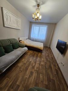 a living room with a couch and a bed at Яровиця 61 in Lutsk