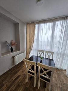 a dining room with a table and chairs and a window at Яровиця 61 in Lutsk