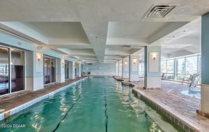 a swimming pool in a building with water in it at Spectacular Ocean View in Daytona Beach
