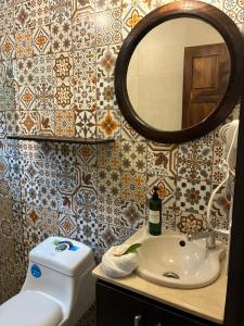 a bathroom with a sink and a mirror at Cabinas El Quetzal in San Gerardo de Dota +56 photos