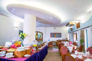 a dining room with tables and chairs in a restaurant at HOTEL LAKE CASTLE - Parkview in Dhaka