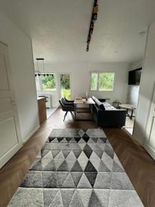 a living room with a black and white rug at Aurora Apartament in Inari