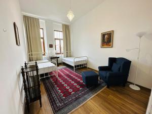 a living room with a bed and a chair and a rug at Central Serenity near Piata Unirii in Oradea