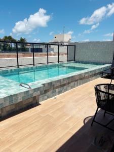 a swimming pool on top of a building at Mares 502 in Tambaú