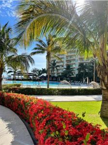 a view of a resort with palm trees and flowers at Puerto Vallarta Del Canto Luxury in Bucerías