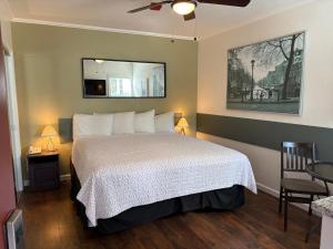 a bedroom with a bed and a ceiling fan at Bide-A-Wee Inn and Cottages in Pacific Grove
