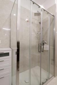 a shower with a glass door in a bathroom at b&b la cattedrale in Avezzano