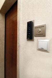 a remote control on a wall next to a door at b&b la cattedrale in Avezzano +22 photos