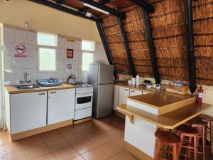 a kitchen with white appliances and wooden counter tops at Amanda's Retreat in Buffelspoort