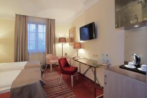 a hotel room with a bed and a desk at Hotel Branicki in Białystok