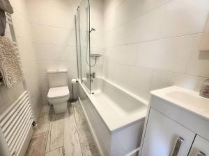 ein weißes Badezimmer mit Toilette und Waschbecken in der Unterkunft 1 Belmont Court in Woolacombe + 9 Fotos