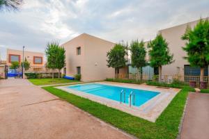 a swimming pool in the yard of a house at Atlantic View Duplex Tawenza Bay in Taghazout