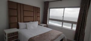 Postel nebo postele na pokoji v ubytování Sand & Sea Holiday Accommodation