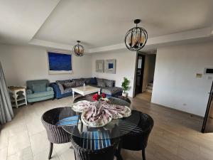 a living room with a table and chairs at Atlantic View Duplex Tawenza Bay in Taghazout