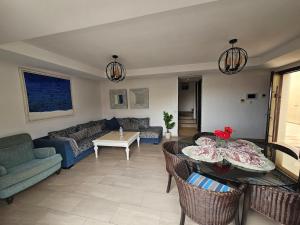 a living room with a couch and a table at Atlantic View Duplex Tawenza Bay in Taghazout