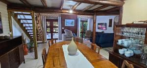 a room with a wooden table with a vase on it at Casa de praia com piscina e jacuzzi totalmente privativa in Imbituba