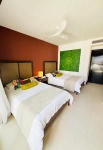 En eller flere senge i et værelse på Aldea Thai Downtown Oceanview Residences