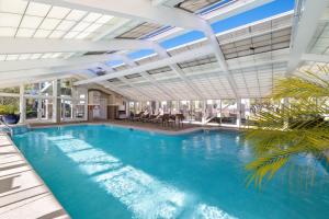 a large swimming pool with a large ceiling at Florencia 708 by Liquid Life in Pensacola