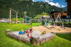 a playground in a park with toys in a sandbox at Haarlehenhof in Grossarl