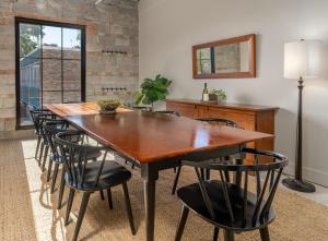 a dining room with a wooden table and chairs at Meeting House Boutique Hotel in Falls Church