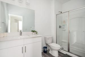 ein weißes Badezimmer mit Toilette und Dusche in der Unterkunft Luxury 5Beds 3Baths 2Balcony Penthouse 542Blvd in Atlanta